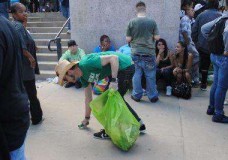 Dwaine Witt, a multiple sclerosis patient, picks up trash at a recent event. Some medical-marijuana dispensaries have donated their time for charitable causes. (Photo via Green Team)